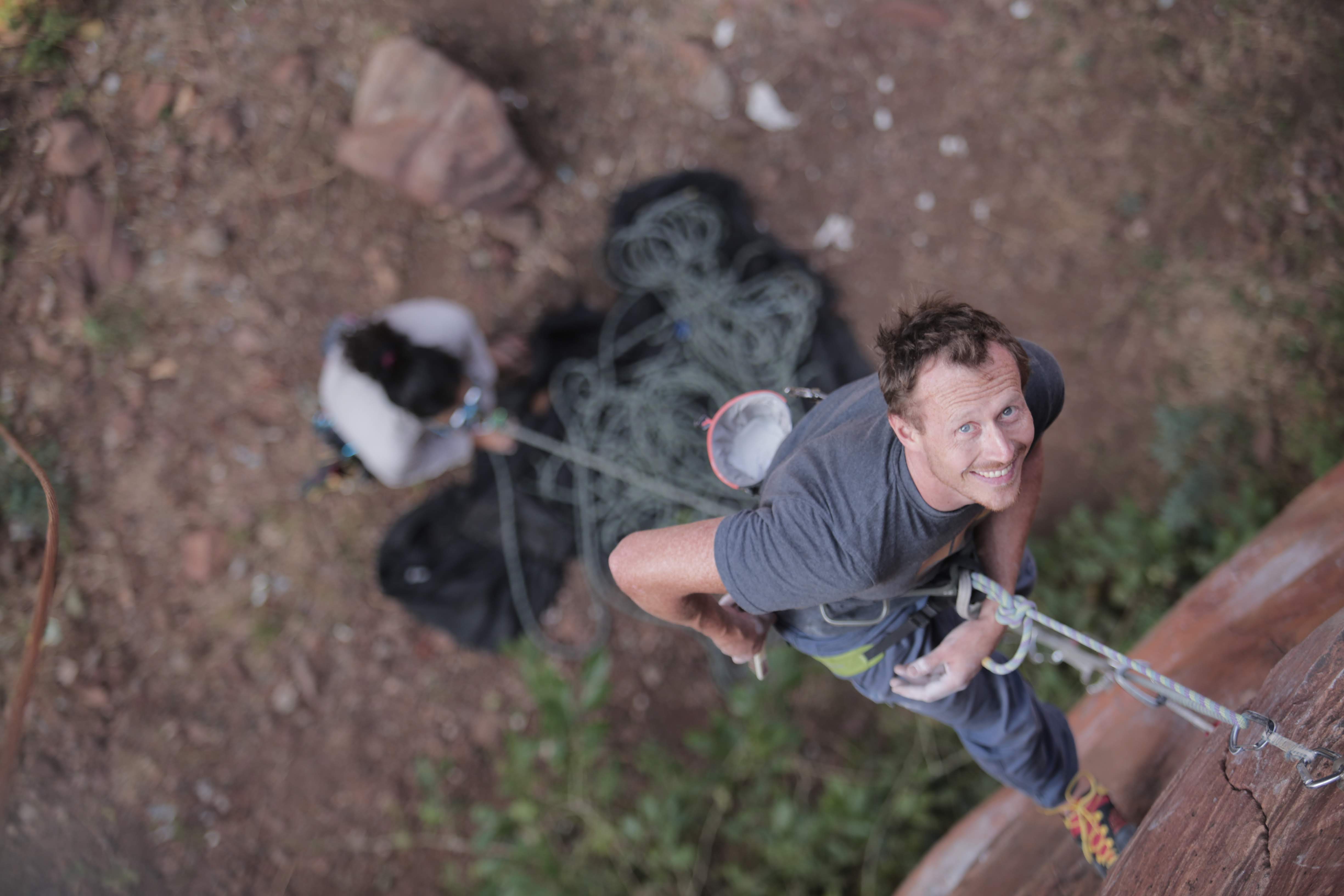 Picture of Tuffenup founder hanging on a climbing rope in Badami India, taken from above