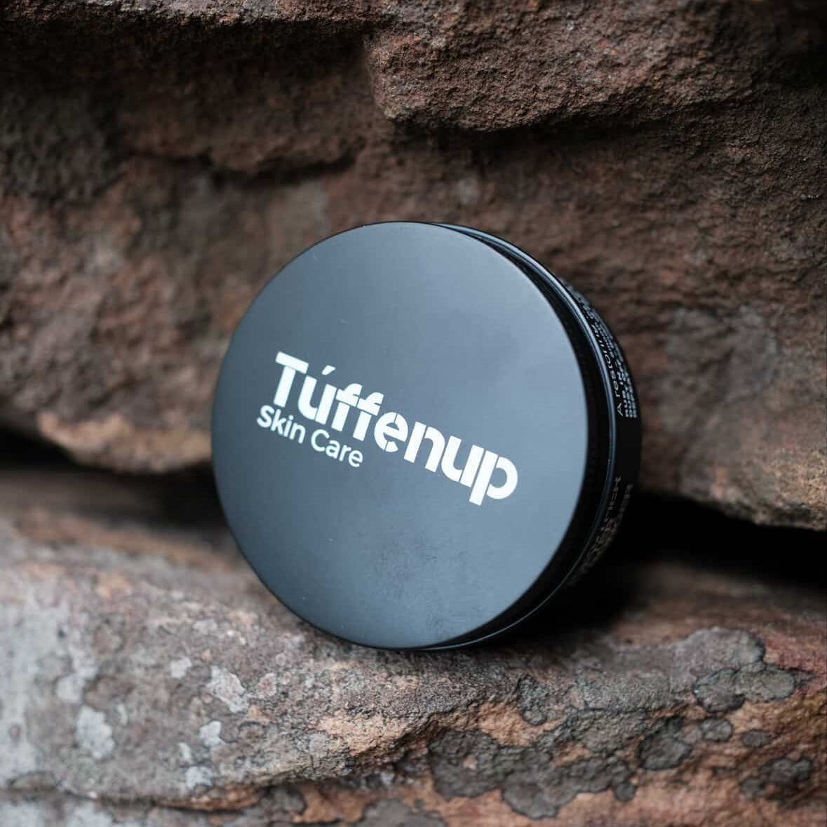 150ml Aluminium tin of Tuffenup's HARD GRIT exfoliating skin care on a stone surface